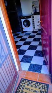 an open door to a kitchen with a checkered floor at Buon Riposo in Córdoba