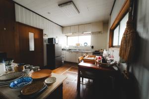 a kitchen with a table and a dining room at 柿畑の宿 Private stay with farm and house all to yourself in Katsuragi