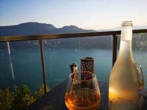 a bottle of wine and a glass on a table at Studio indépendant de 2 à 4 personnes in La Biolle