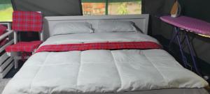a white bed in a room with two chairs at Destiny Paradise in Amagoro +3 photos