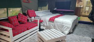 a bedroom with a bed and a couch and a chair at Destiny Paradise in Amagoro