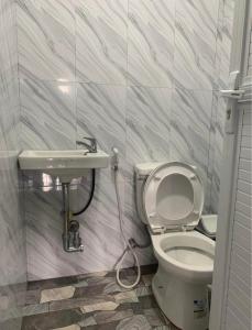 a bathroom with a toilet and a sink at Harmony Mines in Baguio +1 photo