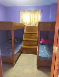 a bedroom with two bunk beds and a window at Harmony Mines in Baguio