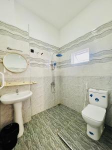 a bathroom with a toilet and a sink at Messiah Royal Residence in Negombo +44 photos