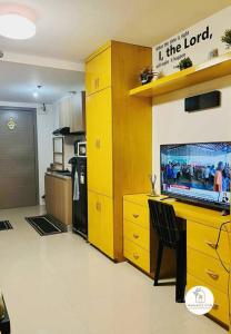 a kitchen with a desk with a laptop on it at Bernwood Tower IloIlo - Heavens Crib in Iloilo City