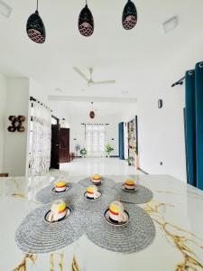a room with a table with hats on it at Messiah Royal Residence in Negombo