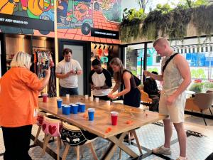 a group of people standing around a wooden table at Lub d Bangkok Chinatown - Steps from Sam Yod MRT Station in Bangkok +72 photos