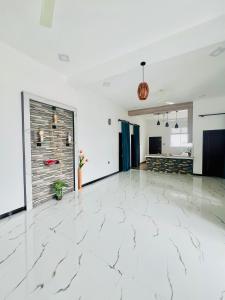 an empty room with a white marble floor at Messiah Royal Residence in Negombo