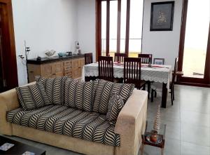 a living room with a couch and a table at Tusker Home stay in Sri Jayewardenepura Kotte +10 photos