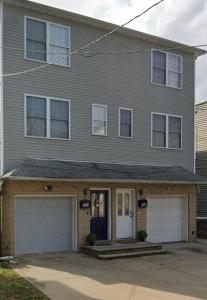 a house with a garage in front of it at Comfortstayrus in Orange