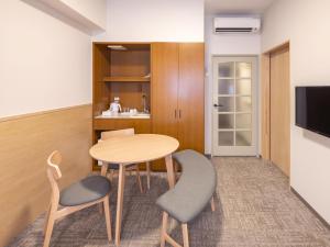 a small room with a table and two chairs at Apartment Hotel DIG the OSAKA in Suita +76 photos