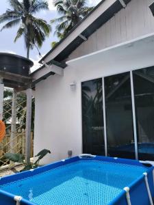 a swimming pool in front of a house at Kampung Cottage Bagan Datuk in Selekoh