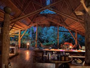 a dining area of a resort with a large wooden ceiling at Maravilla Ojo Del Mar Naturelodge in Puerto Jiménez +20 photos