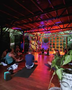 a group of people sitting in a yoga class at Maravilla Ojo Del Mar Naturelodge in Puerto Jiménez