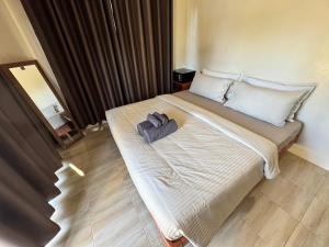 a hotel room with a bed with a towel on it at O Zen Resort in Ko Man Nai