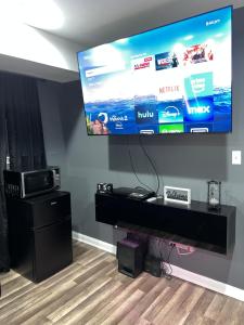 a large flat screen tv hanging on a wall at Comfortstayrus in Orange +19 photos