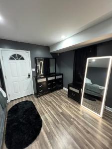 a bedroom with a mirror and a bed and a door at Comfortstayrus in Orange