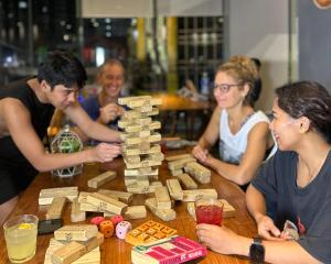 a group of people sitting around a table playing a board game at Lub d Manila Makati - Central Makati, Near Nightlife in Manila +105 photos