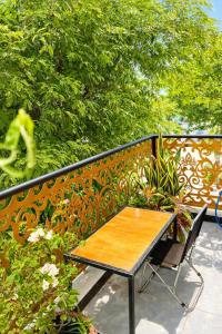 a wooden table and a chair on a fence at Lộc Vừng Homestay in Phan Thiet