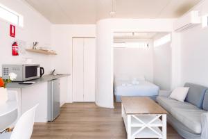 a living room with a couch and a table at Eden Bay Mornington in Capel Sound