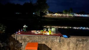 a table with food and drinks on top of a wall at Homestay Baan Ik-ka-lik in Nan