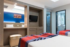 a bedroom with a large bed and a tv at Bangkok Loft at Nana Station in Bangkok +79 photos