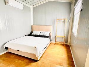 a bedroom with a bed in a small room at Rossaliya Cottage in Taiping