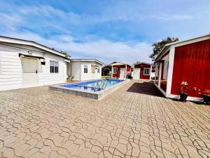 a courtyard with a swimming pool between two buildings at Rossaliya Cottage in Taiping +5 photos