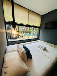 a large bed in a room with a window at Bacalar 102 Hotel in Bacalar +11 photos