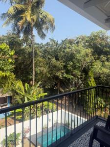 a view from the balcony of a resort with a swimming pool at Henmil Hideaway in Anjuna