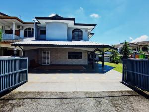 a house with a gate in front of it at Spacious 4BR Corner with Pool Table in Ipoh