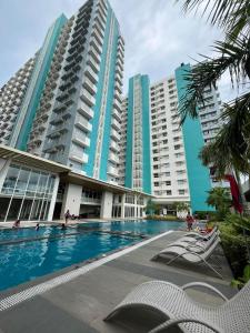 a swimming pool in front of two tall buildings at Hailey's Place Unit 2 in Bacolod