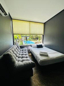a bedroom with a large bed and a window at Bacalar 102 Hotel in Bacalar