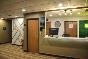 a lobby with a reception desk and a phone at Super 8 by Wyndham Antigo in Antigo