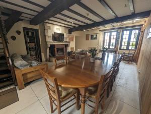a large dining room with a wooden table and chairs at Relais de la vallée de l'ource in Villars-Montroyer