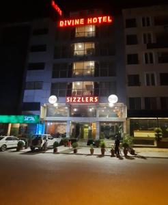 a hotel with a hotel sign in front of a building at Divine Hotel1 in Islamabad