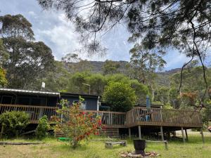 a house with a large deck in a yard at Grampians Nest in Halls Gap