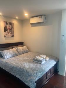 a bedroom with a bed with a picture on the wall at Amazing Spacious Seaview Condo in North Pattaya +45 photos