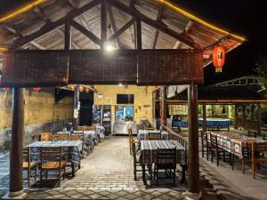a restaurant with tables and chairs in a building at Yangshuo Loong Old House in Yangshuo +36 photos