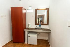 a bathroom with a sink and a mirror at Elephant Path by Alpine Resorts in Habarana +37 photos