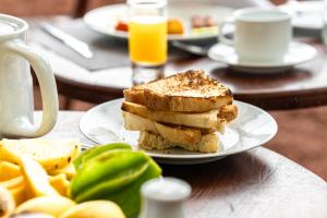 a plate of food with toast on a table at Elephant Path by Alpine Resorts in Habarana
