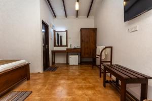 a room with three beds and a mirror in it at Elephant Path by Alpine Resorts in Habarana