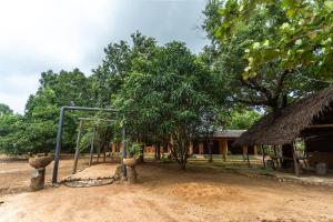 a playground in front of a house with a swing at Elephant Path by Alpine Resorts in Habarana