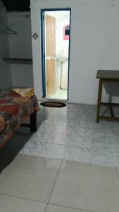 a bedroom with a door open to a bathroom at G naik part 2 in Arambol