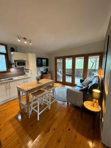 a kitchen and living room with a table and a couch at The Green Room Wattle Glen in Wattleglen