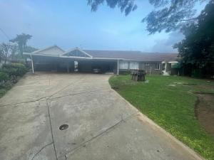 a house with a yard with a driveway at 33 Boeren Guesthouse in Vryheid