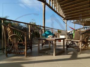 a patio with two chairs and a table on a porch at Seaside Nord in Máncora