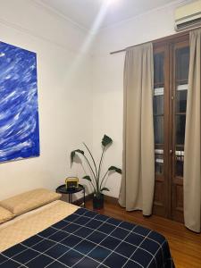 a bedroom with a bed and a painting on the wall at Av corrientes 1 in Buenos Aires +18 photos