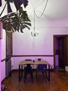 a dining room with a table and chairs and a chandelier at Av corrientes 1 in Buenos Aires