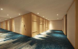 an empty locker room with wooden cabinets and blue floors at Via Inn Prime Kumamoto in Kumamoto